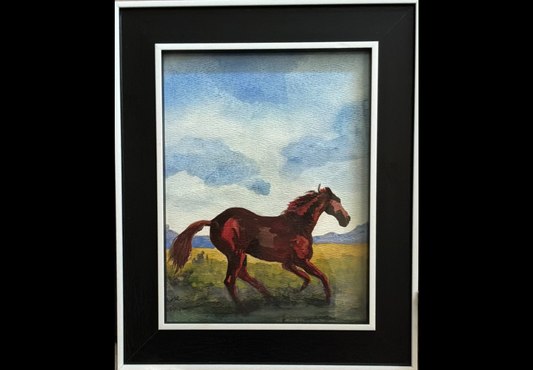 A framed painting of a brown horse running through a grassy field under a blue sky, set in a black frame with a white mat.